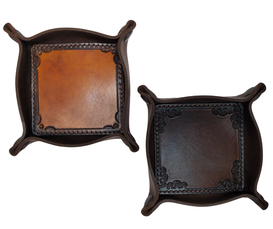 The Franklin is a stylish handmade real leather "catchall" valet tray is made from 2 layers of cowhide leather. It's a little different than our other trays because of the Hand Stamped and stained inside layer. Outer layer is a Bison brown color with the inside layer being stitched in. The corners are held together with heavy line 24 Antique Brass colored snaps, for laying flat for travel, a place for placing keys, wallet, coins.  Made in our shop just outside Nashville in Smyrna, TN.