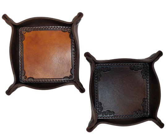 The Franklin is a stylish handmade real leather "catchall" valet tray is made from 2 layers of cowhide leather. It's a little different than our other trays because of the Hand Stamped and stained inside layer. Outer layer is a Bison brown color with the inside layer being stitched in. The corners are held together with heavy line 24 Antique Brass colored snaps, for laying flat for travel, a place for placing keys, wallet, coins.  Made in our shop just outside Nashville in Smyrna, TN.