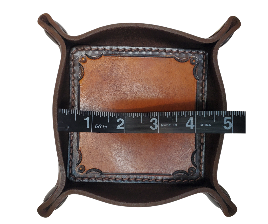 The Franklin is a stylish handmade real leather "catchall" valet tray is made from 2 layers of cowhide leather. It's a little different than our other trays because of the Hand Stamped and stained inside layer. Outer layer is a Bison brown color with the inside layer being stitched in. The corners are held together with heavy line 24 Antique Brass colored snaps, for laying flat for travel, a place for placing keys, wallet, coins.  Made in our shop just outside Nashville in Smyrna, TN.