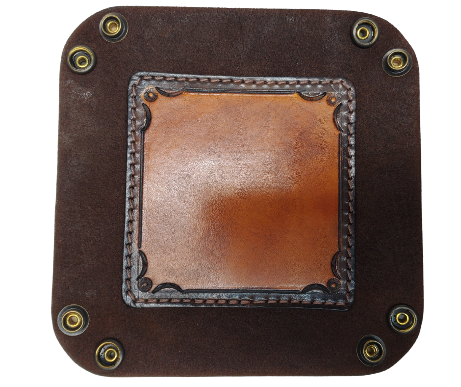 The Franklin is a stylish handmade real leather "catchall" valet tray is made from 2 layers of cowhide leather. It's a little different than our other trays because of the Hand Stamped and stained inside layer. Outer layer is a Bison brown color with the inside layer being stitched in. The corners are held together with heavy line 24 Antique Brass colored snaps, for laying flat for travel, a place for placing keys, wallet, coins.  Made in our shop just outside Nashville in Smyrna, TN.