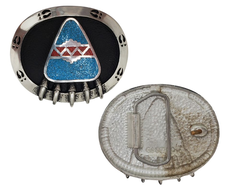 The symbol of the Bear Claw is thought to carry power and strength. This beautiful Buckle made of lead-free pewter with turquoise &amp; coral chip inlay. It's available in our shop located just outside of Nashville in Smyrna, TN.

3 in x 2.375 in.
Made in the USA.