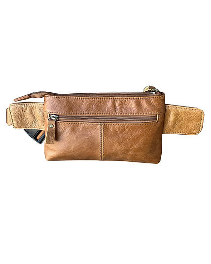 Cowhide leather waist pack. Fully adjustable nylon waist belt with snap buckle closure. Additional leather extension panels around waist strap. Spacious main compartment with 1 interior zipper pocket and 2 throw pockets. Front side has 2 full length exterior zipper pockets. Back side has a discrete zipper pocket. Bronze zipper hardware with leather pulls. Get yours at our local Smyrna, TN shop.

Size: 5¼”x 9”x 1½”