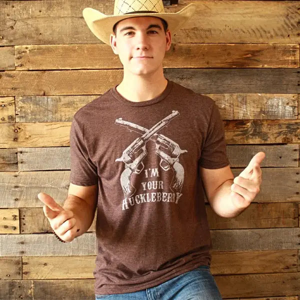 The Huckleberry in Brown is a screen printed men's t-shirt. Your support makes our success possible. Available online and in our retail shop in Smyrna, TN. Made of super soft; 50% ring spun cotton; 50% poly. Pre-shrunk.

Image on the front chest area, brand logo on left sleeve