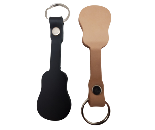 Check out our Veg-Tan in Black or Natural leather keychain in the shape of the Classic Nashville Acoustic Guitar. BUY MORE and SAVE! Made in our shop in Smyrna, TN, just outside Nashville. Key ring is split ring and leather is attached with a single rivet. Size is approx. 4" long including ring.