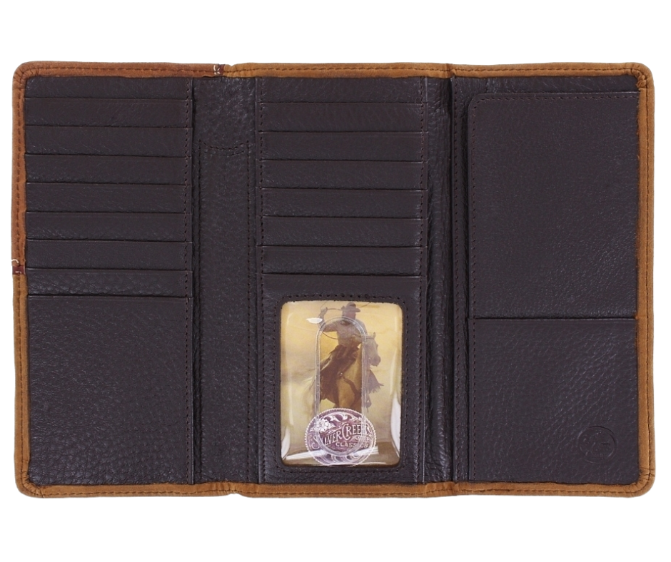 Carry this handsome checkbook wallet, with Western flavored stitching. The Aged Bark colored leather, the Bronc concho in a studded, stitched frame. A unique tri-fold style set this one apart with a soft inside is built to fit 15 cards, checkbook, 2 cash slots, pen, ID window. It's sized at 6 3/4" tall by 3 3/4" wide. Available in our Smyrna, TN store, a short drive id your in Nashville visiting. Silver Creek is Made by Brighton.