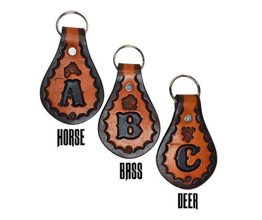 Our 1970 throwback style Leather keychain is hand stamped similar to our popular belts.  Great for identifying luggage, backpacks, or your keys! Available in the below choices All colored in our popular 2 TONE BROWN, pick one or a few, makes great gifts! Made in our Smyrna, TN shop. Please type desired initial in CUSTOM box.