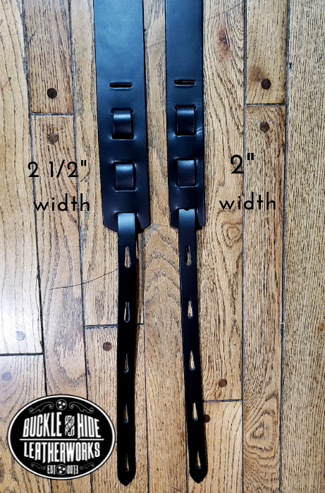 You don't get more classic Western than a handcrafted Glossy black leather guitar strap! Featuring a ornate scroll pattern 3 piece western buckle set in the front position of the strap. Each size of buckle set is similar but not the same, so check out pictures. It's made from 1/8" thick drum dyed cowhide leather and looks great with a vintage "Tele". The main strap is made from a single strip of leather with beveled and .  Made just outside Nashville in Smyrna, TN. 