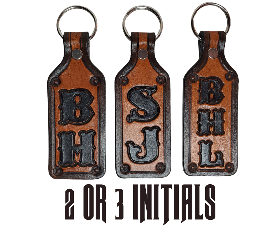 Our Customizable "1973" Medium Leather keychain embossed similar to our popular belts.  Great for identifying luggage, backpacks, or your keys! Available in the below choices All colored in our popular 2 TONE BROWN, pick one or a few. Made in our Smyrna, TN shop. 2 initials will be 1" size, 3 initials will be 3/4" size. Please type desired name in CUSTOM box.  Measures...approx. 1" x 4"