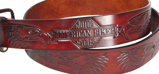 This USA made veg-tan leather belt is approx. 1/8" thick, 1 1/2"width with no fillers to split or rip apart. The belt features American Biker and Eagle heads embossed around the entire belt. The leather is comfortable from day one.  Buckle is silver colored and snapped on for easy buckle change. We don't make this belt but it's Buckle and Hide approved and still made in the USA