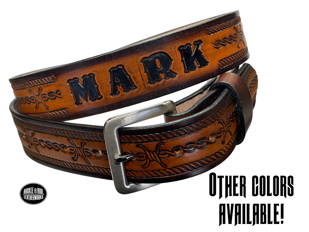 Barb Wire a western-inspired twist to any look. Made from premium veg-tan cowhide and featuring a barb wire icon design, the "Riding Fence" Name Leather Belt is the perfect way to add a touch of rustic  to your wardrobe. Hailing from our Smyrna, TN shop just outside of Nashville, TN, this belt also features an easy-to-swap buckle, so you can keep your style fresh. 