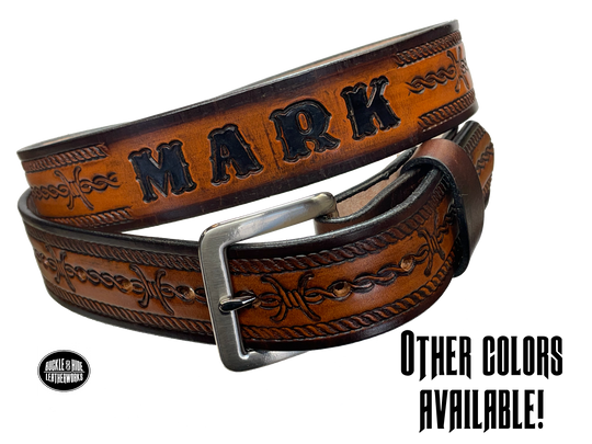 Barb Wire a western-inspired twist to any look. Made from premium veg-tan cowhide and featuring a barb wire icon design, the "Riding Fence" Name Leather Belt is the perfect way to add a touch of rustic  to your wardrobe. Hailing from our Smyrna, TN shop just outside of Nashville, TN, this belt also features an easy-to-swap buckle, so you can keep your style fresh. 