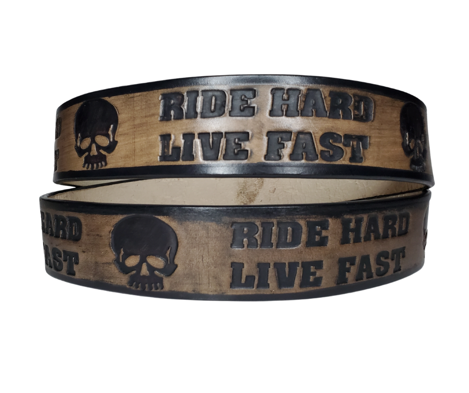 "The Daytona" is a handmade real leather belt made from a single strip of cowhide shoulder leather that is 8-10 oz. or approx. 1/8" thick. It has hand burnished (smoothed) edges and features the mantra "RIDE HARD LIVE FAST" and an HD Skull pattern down the center. This belt is completely HAND dyed with a multi step finishing technic. The antique nickel plated solid brass buckle is snapped in place with heavy snaps.  This belt is made just outside Nashville in Smyrna, TN.