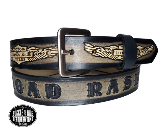 "The SGT AT Arms" is a handmade real leather belt made from a single strip of cowhide shoulder leather that is 8-10 oz. or approx. 1/8" thick. It has hand burnished (smoothed) edges and the Classic Wings and Shield pattern down the center. This belt is completely HAND dyed with a multi step finishing technic. The antique nickel plated solid brass buckle is snapped in place with heavy snaps.  This belt is made just outside Nashville in Smyrna, TN.