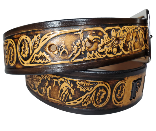 "The Bullrider" is a handmade real leather belt made from a single strip of cowhide shoulder leather that is 8-10 oz. or approx. 1/8" thick. It has hand burnished (smoothed) edges and a western influenced Rodeo events pattern. This belt is completely HAND dyed with a multi step finishing technic. The antique nickel plated solid brass buckle is snapped in place with heavy snaps.  This belt is made just outside Nashville in Smyrna, TN.