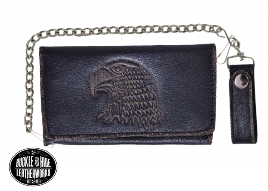 It's Cowhide LEATHER with a Eagle Head embossed that's slightly distressed brown! Popular Long Style Tri-fold Chain Wallet.  Nylon lined 6 card slots in the middle with a I.D. slot, 1 nylon lined zippered pocket, 3 underneath cash slots, for all your important stash. It's imported but it's Buckle and Hide approved. Complete with a 18" chrome plated chain (including leather belt loop. Standard long tri-fold size. Size is 7" x 3 1/2" when snapped closed.