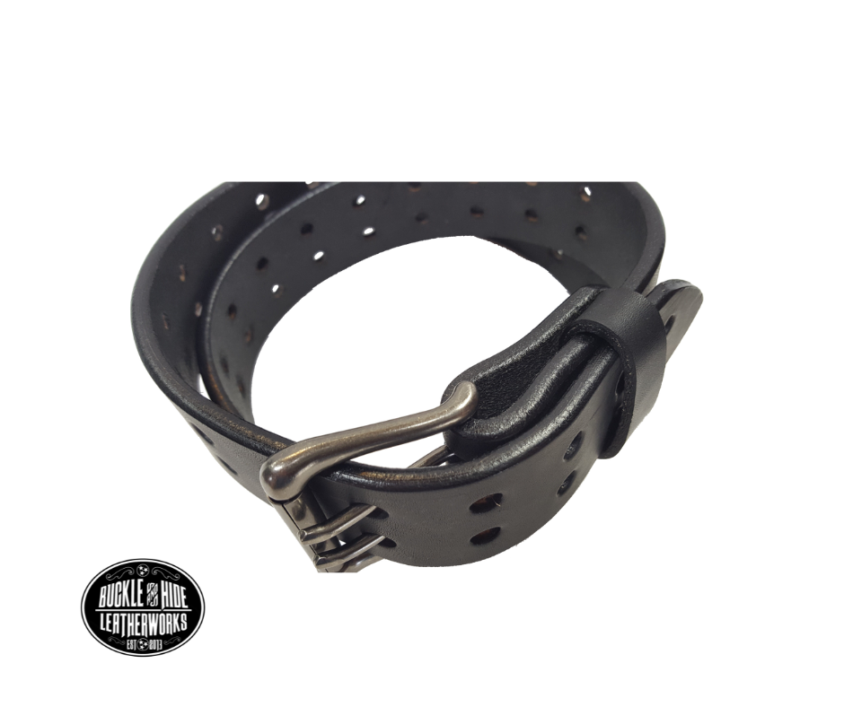 Our handmade Extra Heavy double hole leather belt is made from 12-14 oz. (approx 1/4" thick) bridle cowhide leather that is drum dyed all the way through. The double holes run the length of the belt. Buckle is a heavy double pronged roller buckle with antique nickel plated finish that is snapped in place on the end.  The width is 1 3/4", edges are smoothed and painted.  Made just outside Nashville in Smyrna, TN.  Available in black or brown.