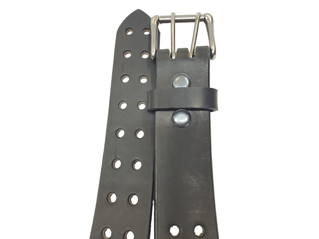 Our handmade Extra Heavy double hole leather belt is made from 12-14 oz. (approx 1/4" thick) bridle cowhide leather that is drum dyed all the way through. The double holes run the length of the belt. Buckle is a heavy double pronged roller buckle with antique nickel plated finish that is snapped in place on the end.  The width is 1 3/4", edges are smoothed and painted.  Made just outside Nashville in Smyrna, TN.  Available in black or brown.