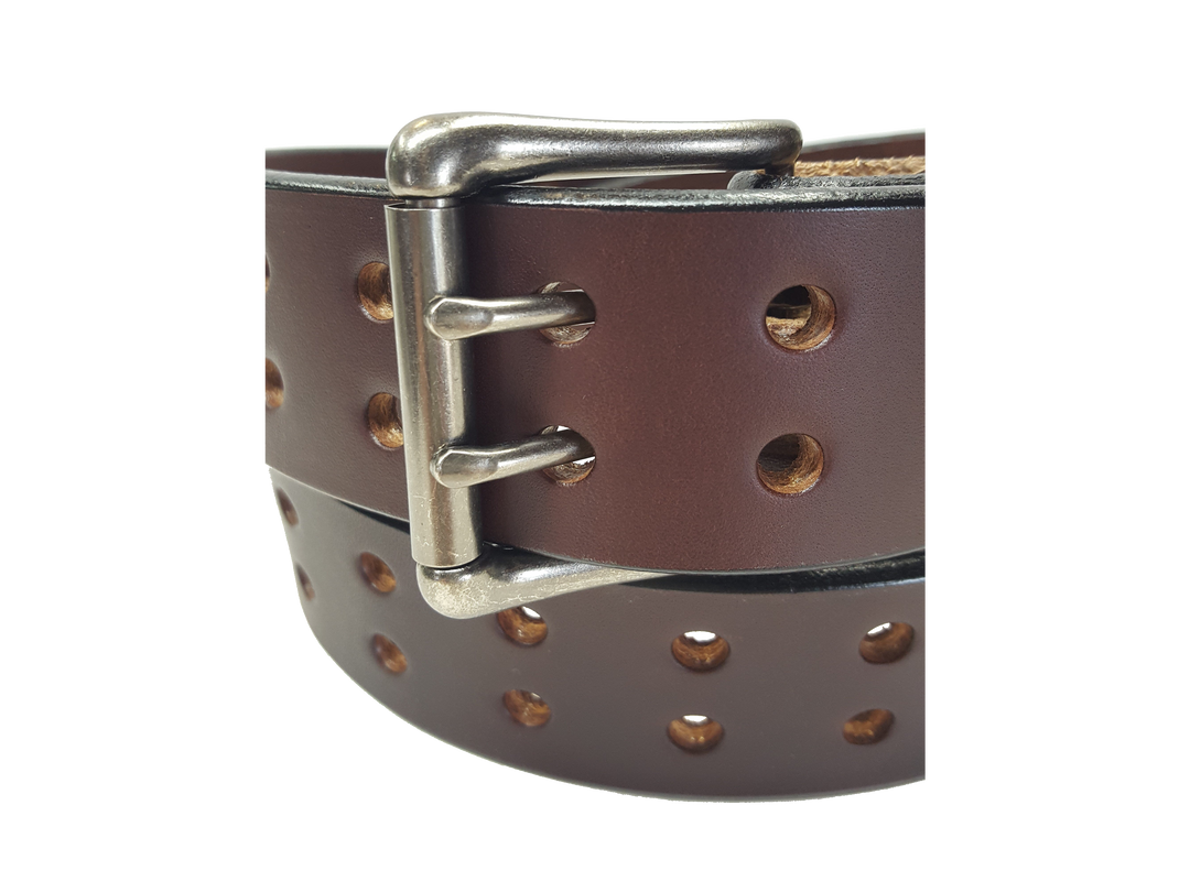 Our handmade Extra Heavy double hole leather belt is made from 12-14 oz. (approx 1/4" thick) bridle cowhide leather that is drum dyed all the way through. The double holes run the length of the belt. Buckle is a heavy double pronged roller buckle with antique nickel plated finish that is snapped in place on the end.  The width is 1 3/4", edges are smoothed and painted.  Made just outside Nashville in Smyrna, TN.  Available in black or brown.