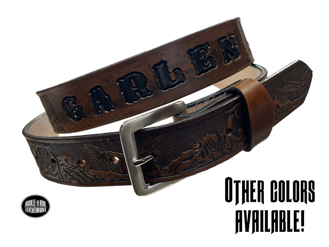 This Eagle Mesa Name Leather Belt offers a unique homage to the American Wild West. Crafted from top-quality Veg tan cowhide and featuring a detailed Eagle-over-desert embossing, this belt is a stylish and practical choice. It's even customizable with name and multiple finish options. Handmade near Nashville in Smyrna TN.