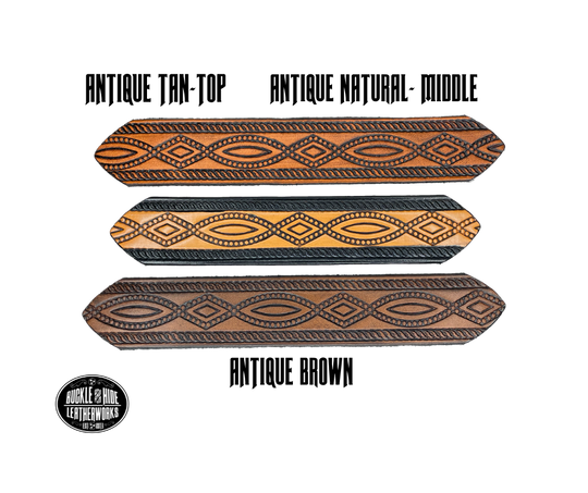 This solid strip of Veg Tan cowhide, is hand stained in classic 2 tone antique brown, with smooth, finished edges. Embossed with a classic FIGURE 8 pattern you'll see "The Stranger" wearing in well known "spaghetti" westerns down length of belt, or have name added to scene up to 8 letters. Belt thickness is approx. 1/8", and 1 1/2" wide. Sizes available are 34" to 44" from buckle end to hole most worn. Attached with 2 snaps is a Brushed Nickel plated solid brass buckle. 