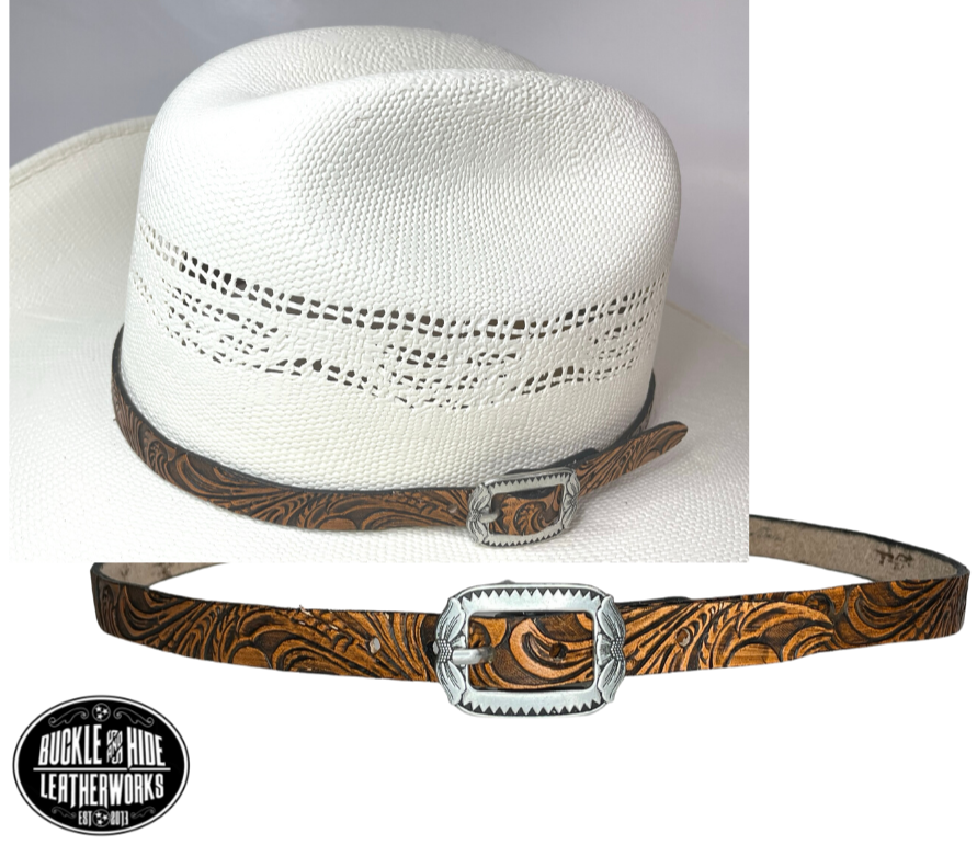 A classic Western tooled pattern with a Western styled Antique nickel center bar buckle completes our Embossed Hand stained leather hatband. Band is 1/2" wide will fit up to size 7 1/2 hat. Matches our Rustler Belt. Fit's most any hat with adjustable bead and leather 1/8" string. Will fit most WESTERN crowned hats. Made in our Smyrna Tn. shop.   