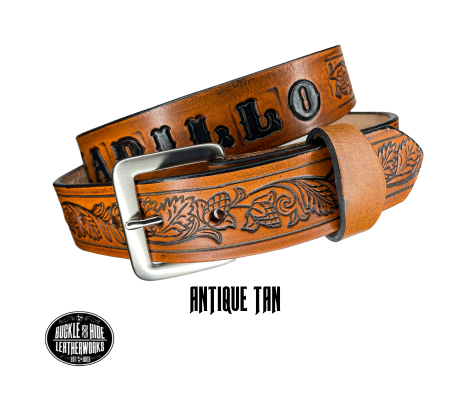 This solid strip of Veg Tan cowhide, is hand stained in 3 brown options, with smooth, finished edges. Embossed with Western Vine down length of belt, or have name added to scene up to 8 letters. Belt thickness is approx. 1/8", and 1 1/2" wide. Sizes available are 34" to 44" from buckle end to hole most worn. Attached with 2 snaps is a Brushed Nickel plated solid brass buckle. 