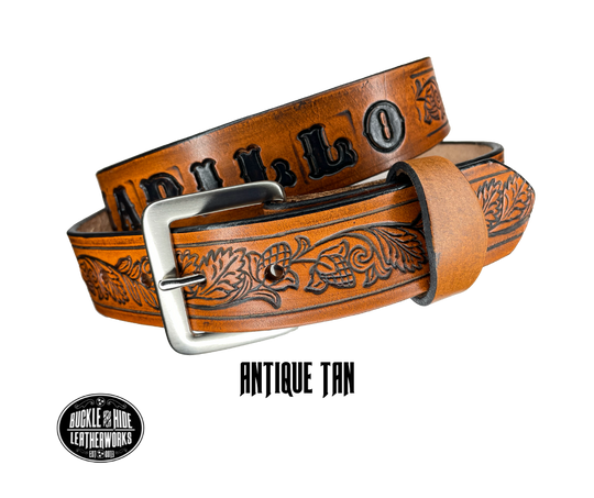 This solid strip of Veg Tan cowhide, is hand stained in 3 brown options, with smooth, finished edges. Embossed with Western Vine down length of belt, or have name added to scene up to 8 letters. Belt thickness is approx. 1/8", and 1 1/2" wide. Sizes available are 34" to 44" from buckle end to hole most worn. Attached with 2 snaps is a Brushed Nickel plated solid brass buckle. 