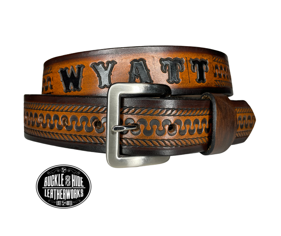 This belt's got some class! Embossed with a classic western serpentine/rope pattern and made with 1/8" thick Veg tan cowhide, the "Law Dawg" Name Leather Belt will give you the durability and style to last for miles and miles if you get a bit rowdy - It's made in our Smyrna, TN shop just outside Nashville, TN. Saddle up!