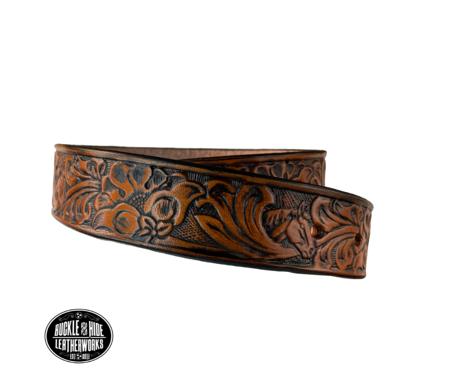 Introduce your little one to the iconic style of the west with the "Lil' Mustang" Leather KIDS/CHILDRENS Name Belt! Durable veg tan leather ensures that your cowboy or cowgirl can look good while feeling comfortable, and a unique western floral design featuring horses adds a touch of fun. A 1 1/4" width with snaps makes swapping out buckles a snap! Proudly made in Smyrna TN, just outside Nashville. 