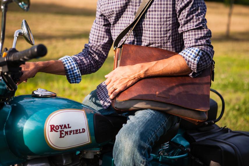 This 2 tone brown leather messenger bag is made from real cowhide leather.&nbsp; Flap is a smooth oil tanned leather with a distressed look and the body has contrasting soft pebbled grain leather. The flap secures with a magnetic snap. Dimensions are approx. 15" by 12" by 3". Back pocket will hold a full size laptop.&nbsp; Inner bag is lined with nylon and leather trim and hardware is brushed nickel. Available for purchase in our retail shop in Smyrna, TN, just outside Nashville.