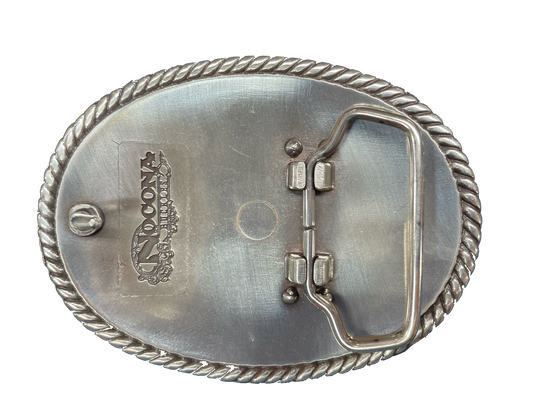 This oval shaped buckle by Nocona has a rope design around the border. It is chrome colored with scroll design etched appearance on surface.  Measures 2 3/4" tall by 3 3/4" wide and fits belts up to 1 1/2" wide.  It is available for purchase in our retail shop in Smyrna, TN, just outside Nashville and also on our online store. Made in Taiwan. Back of buckle pictured.