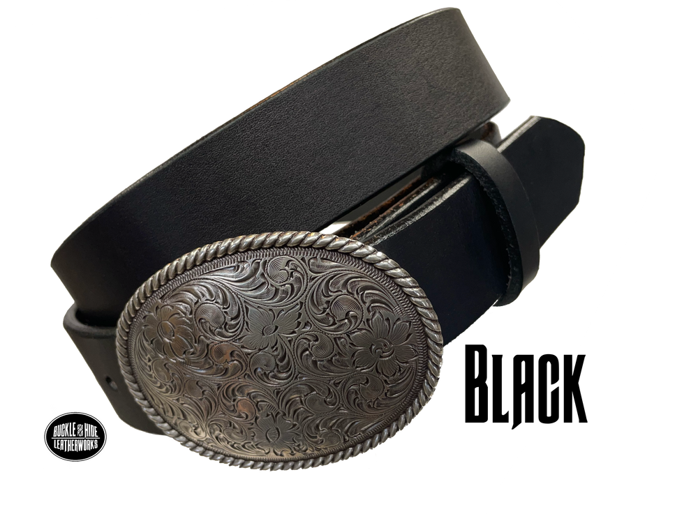 This oval shaped buckle by Nocona has a rope design around the border. It is chrome colored with scroll design etched appearance on surface.  Measures 2 3/4" tall by 3 3/4" wide and fits belts up to 1 1/2" wide. Buckle is made in Taiwan. Belt is a solid strip of leather and made in our shop in Smyrna, TN, just outside Nashville. It is 1 1/2" wide and available in sizes 34"-44" and colors distressed brown, black, and dark brown. It is available for purchase in our retail shop and online store. Black.