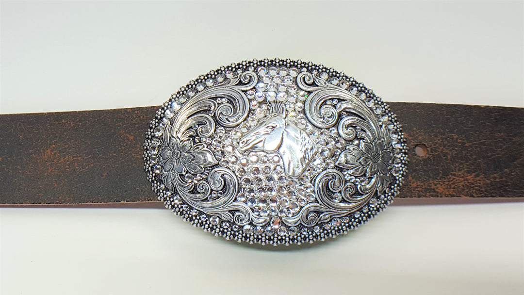 Nocona ladies buckle from Blazin Roxx Dimensions are 2 3/4" tall by 4" wide Has horse head pictured in center of buckle surrounded by rhinestones and scroll design work Available online and in our shop in Smyrna, TN, just outside of Nashville