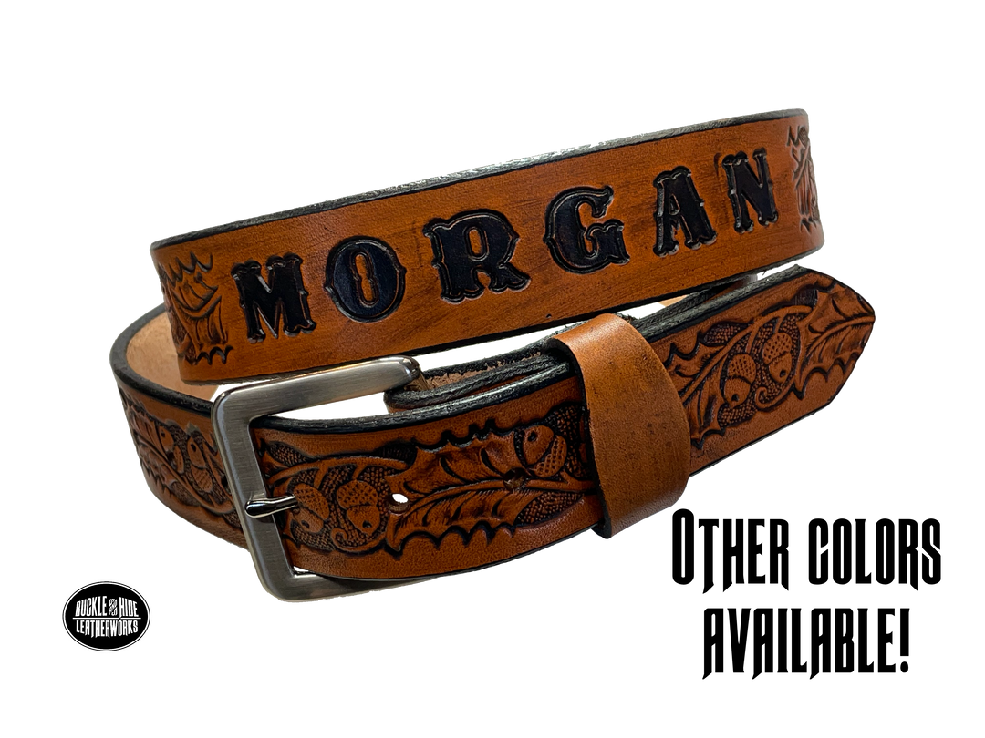 The Tall Oak Name Leather Belt is crafted from strong, high-quality Veg tan leather with an embossed Oak and Acorn pattern. Choose your finish and a name if desired. Its solid Antique nickel brass buckle is easy to change with included snaps, perfect for everyday wear. Handmade outside of Nashville in Smyrna, TN.