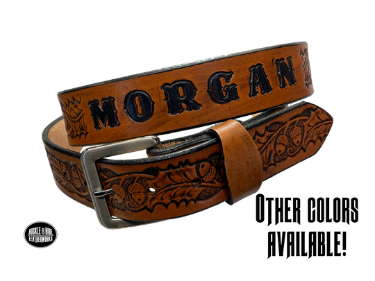 The Tall Oak Name Leather Belt is crafted from strong, high-quality Veg tan leather with an embossed Oak and Acorn pattern. Choose your finish and a name if desired. Its solid Antique nickel brass buckle is easy to change with included snaps, perfect for everyday wear. Handmade outside of Nashville in Smyrna, TN.