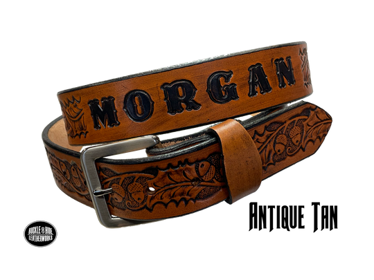 The Tall Oak Name Leather Belt is crafted from strong, high-quality Veg tan leather with an embossed Oak and Acorn pattern. Choose your finish and a name if desired. Its solid Antique nickel brass buckle is easy to change with included snaps, perfect for everyday wear. Handmade outside of Nashville in Smyrna, TN.