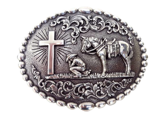 Nocona buckle with beaded edge. Cowboy kneeling at Cross with his trusted horse behind him. A raised floral design perfectly complements this reverent design. Measures 3-1/8" tall by 4" wide  Available online and in our shop in Smyrna, TN, just outside of Nashville