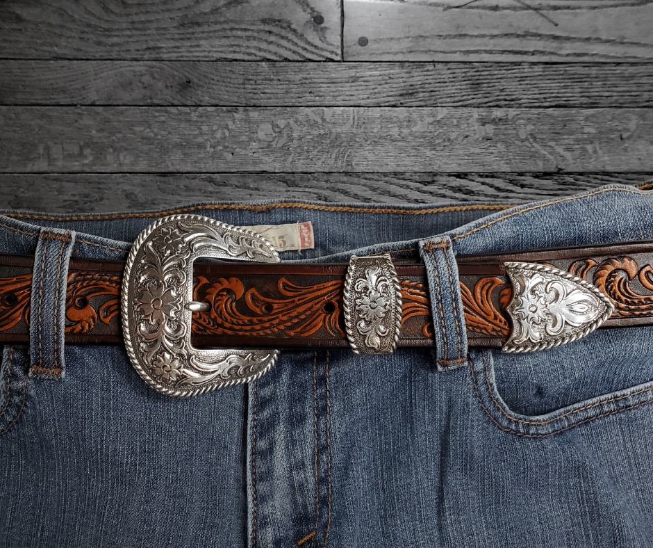 The "Rustler" design is one of our best sellers. But we've added a Classic Western 3 piece buckle set in Antique Nickel that looks great on plain 1 1/2" Black or Brown belt. An easy to wear shape that's not too big, measures approx. 3 7/8" wide by 2 1/2" tall. Belt is made from a single strip of leather in our shop in Smyrna, TN. Buckle is Imported. Available in our shop just outside Nashville in Smyrna, TN as well as online.