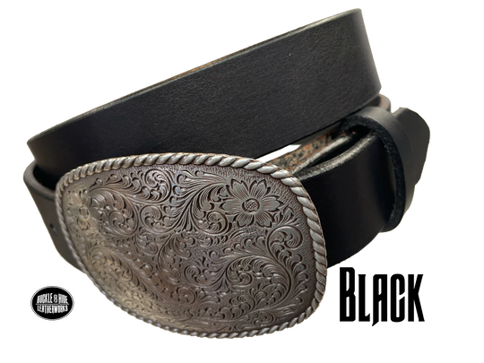 This rectangular shaped buckle has rounded edges with rope design around the border. It is chrome colored with scroll design etched appearance on surface.  Measures 2 3/4" tall by 3 3/4" wide and fits belts up to 1 1/2" wide. Buckle is made in Taiwan. Belt is a single strip of leather that is 1 1/2" wide and available in sizes 34" to 44". Colors are distressed brown, black, and dark brown. Black pictured. Available online and in our retail shop in Smyrna, TN, just outside Nashville.