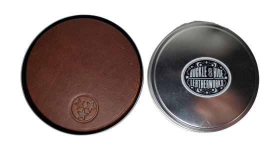 Made in our shop in Smyrna, TN just outside Nashville TN. Real cowhide approx. 3/16"thick in a 3 5/8" diameter coaster.  Embossed with famous Tennessee Tri-Star emblem10 coasters in a tin case. Great for groomsmen gifts, Weddings, Events and more. Contact us for bulk purchases of 50 or 500...