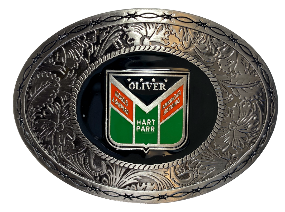 Metal oval buckle with barbed wire and western tooling and Oliver logo in the center. Available online and in our shop just outside Nashville in Smyrna, TN.