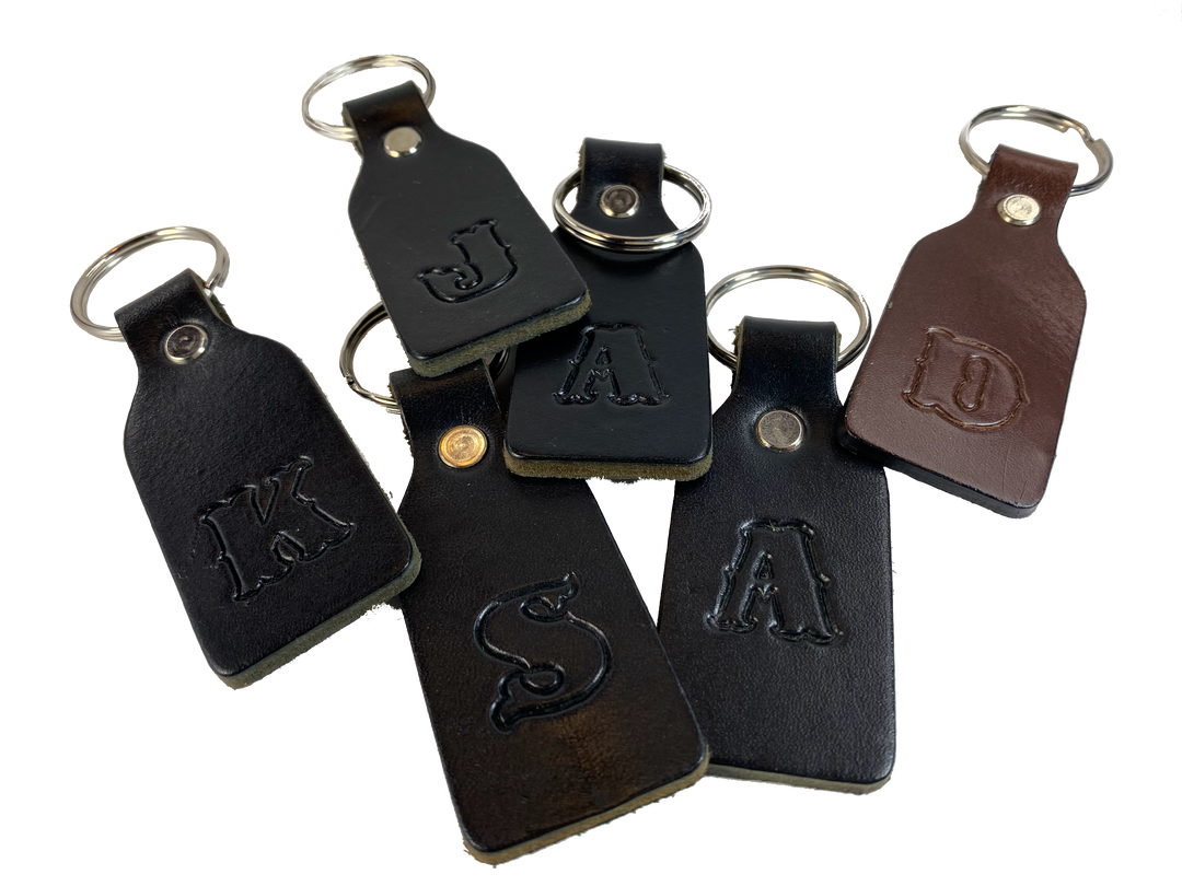 Small Leather keychain embossed with your choice of single letter initial. Great for identifying luggage, backpacks, or you keys! Available in Black or Assorted Brown. Put initial/s in the box. Made in our Smyrna Tn. shop.