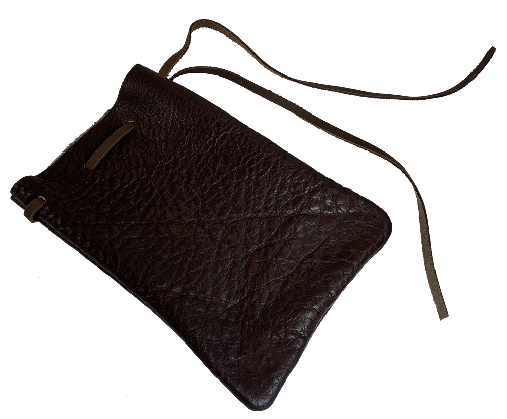 Leather pouch with drawstring. Available in Black and Assorted Brown. Fill it with anything you like, a camera, your rock collection, tools etc. This large leather pouch can be used to hold a small canteen or flask. Made in USA.