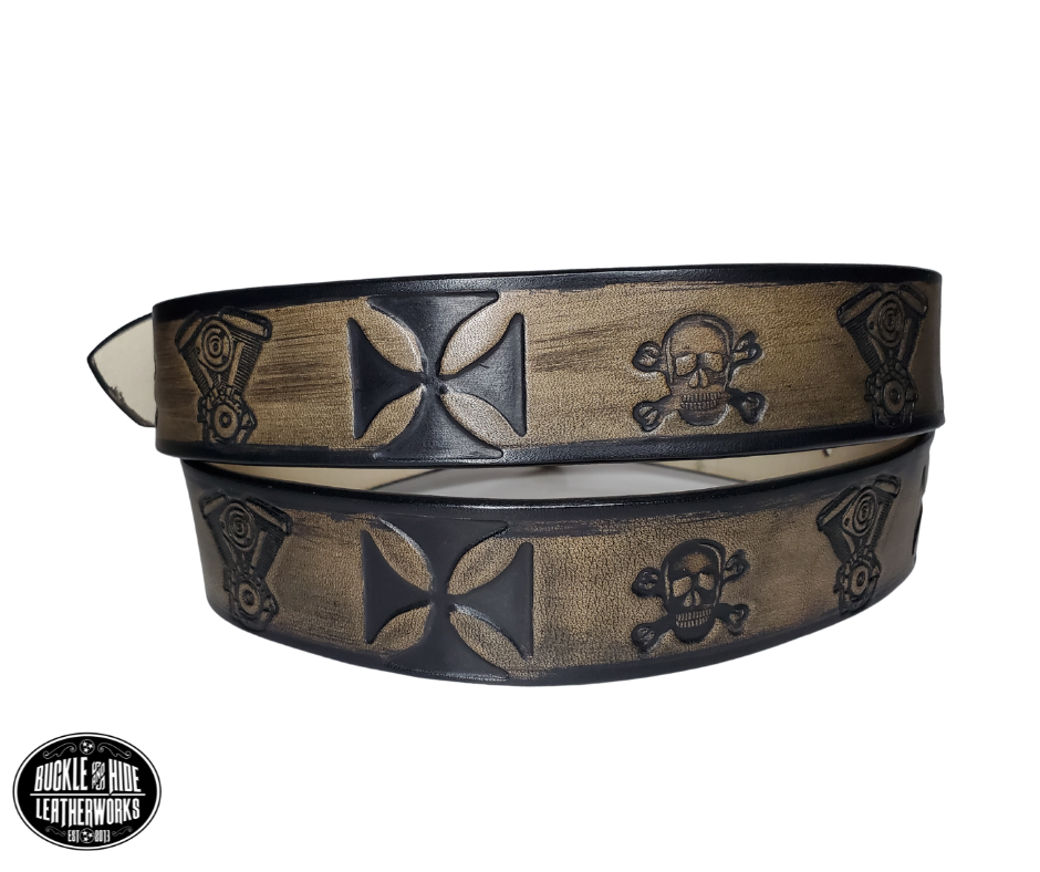 "The Hardtail" is a handmade real leather belt made from a single strip of cowhide shoulder leather that is 8-10 oz. or approx. 1/8" thick. It has hand burnished (smoothed) edges and features a V-twin engine, Skull and Crossbones and Maltese style cross pattern down the center. This belt is completely HAND dyed with a multi step finishing technic. The antique nickel plated solid brass buckle is snapped in place with heavy snaps.  This belt is made just outside Nashville in Smyrna, TN.