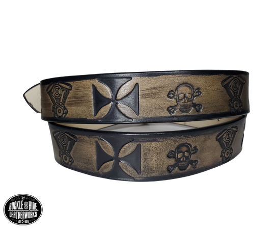 "The Hardtail" is a handmade real leather belt made from a single strip of cowhide shoulder leather that is 8-10 oz. or approx. 1/8" thick. It has hand burnished (smoothed) edges and features a V-twin engine, Skull and Crossbones and Maltese style cross pattern down the center. This belt is completely HAND dyed with a multi step finishing technic. The antique nickel plated solid brass buckle is snapped in place with heavy snaps.  This belt is made just outside Nashville in Smyrna, TN.