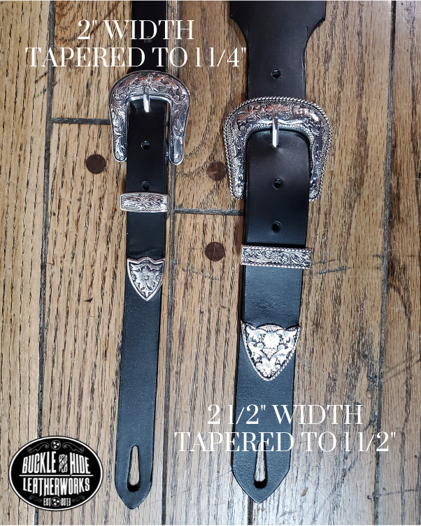 You don't get more classic Western than a handcrafted Glossy black leather guitar strap! Featuring a ornate scroll pattern 3 piece western buckle set in the front position of the strap. Each size of buckle set is similar but not the same, so check out pictures. It's made from 1/8" thick drum dyed cowhide leather and looks great with a vintage "Tele". The main strap is made from a single strip of leather with beveled and .  Made just outside Nashville in Smyrna, TN. 