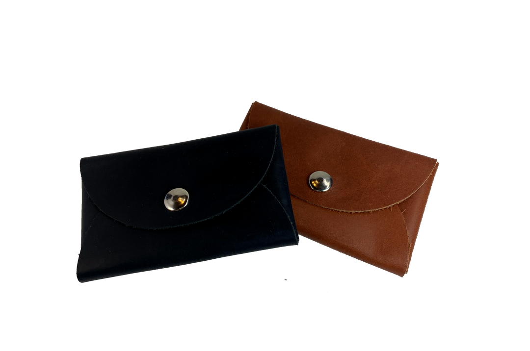 Handmade leather coin wallet with silver colored snap closure  so that coins and other small items may be carried.  Fits in the palm of the hand. BUY MORE and SAVE!  Available in either assorted brown or black leather.  Made in USA